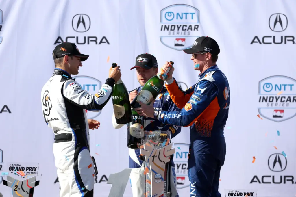 Winning Indycar driver Alex Palou, celebrates with second place finisher...