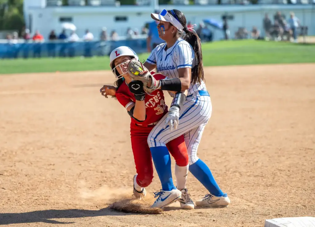 Orange Lutheran second baseman Sierra Nichols, left, collides with La...