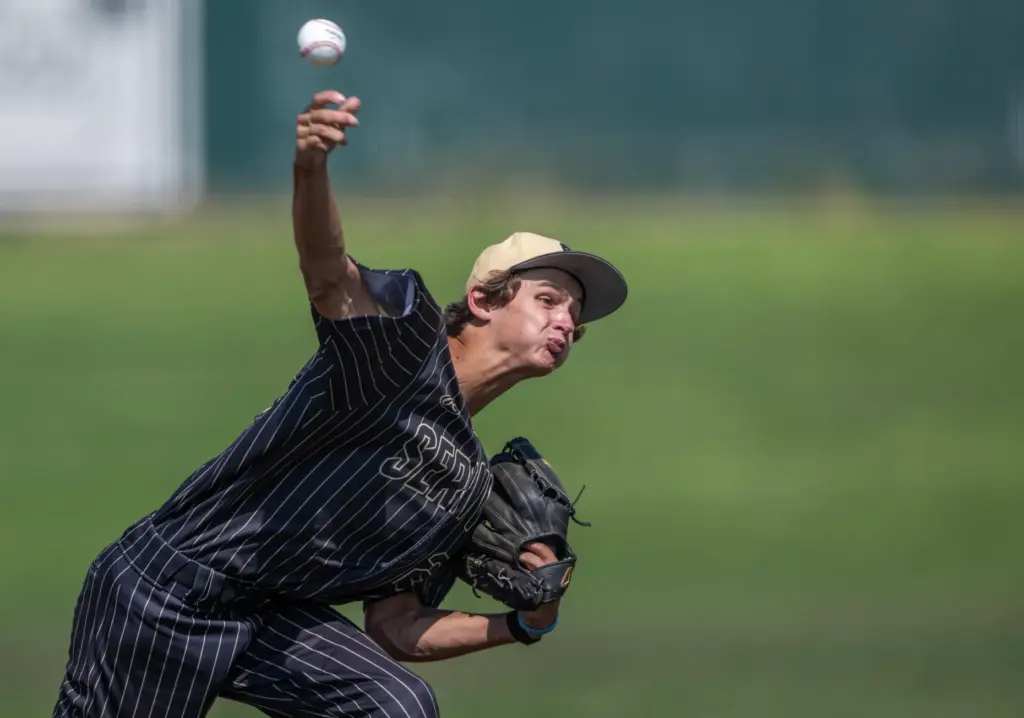 Servite starting pitcher Wyatt Karges throws to home plate during...