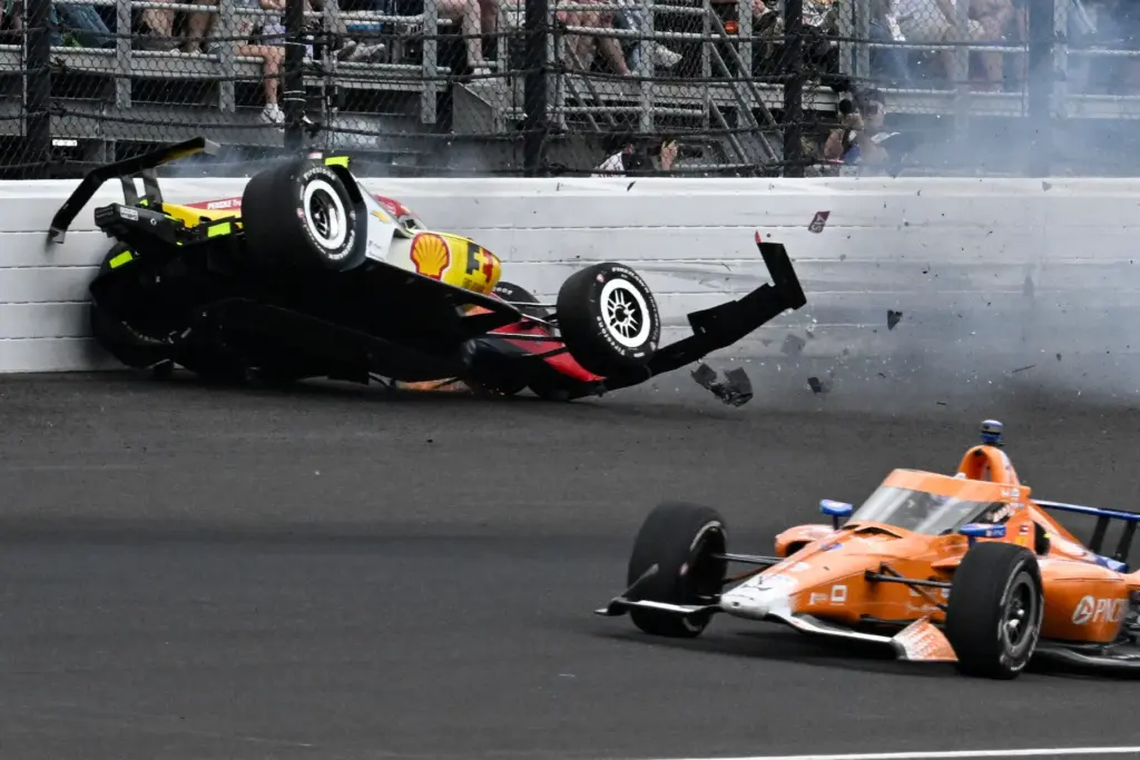 Scott Dixon, right, of New Zealand, drives past Josef Newgarden,...