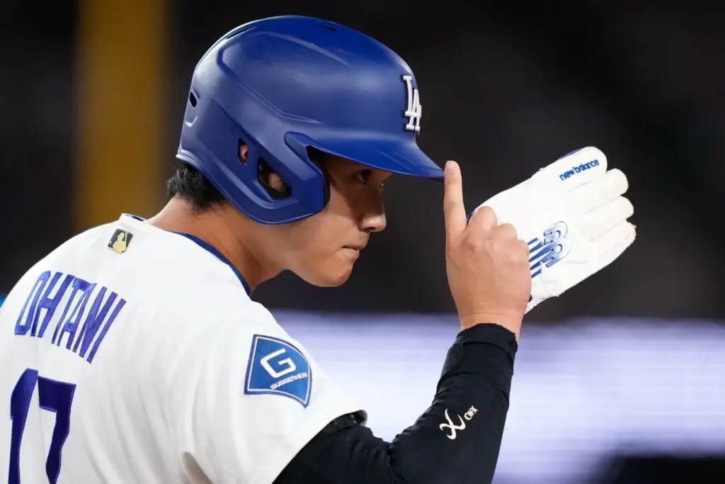 Dodgers star Shohei Ohtani acknowledges the first base umpire as...