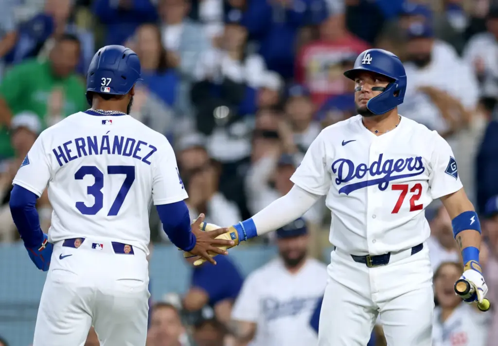 The Dodgers’ Teoscar HernÃ¡ndez, left, celebrates with teammate Miguel Rojas...