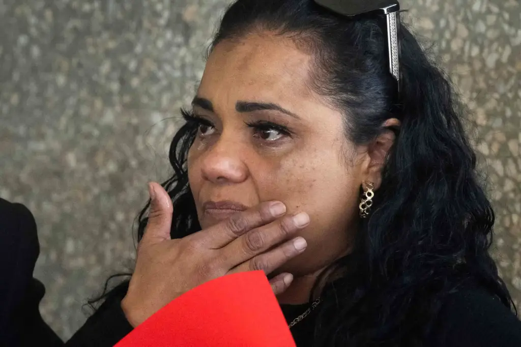 Roxanne Campos is emotional during a rally outside Assemblymember Tina...