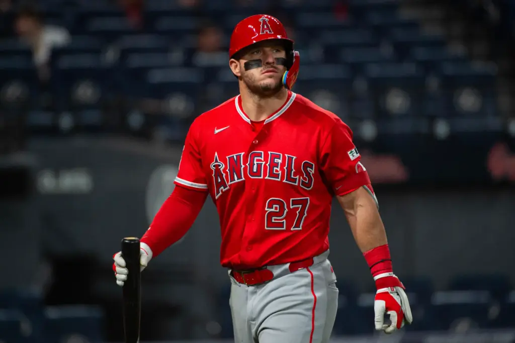 Angels star Mike Trout walks to the dugout after striking...