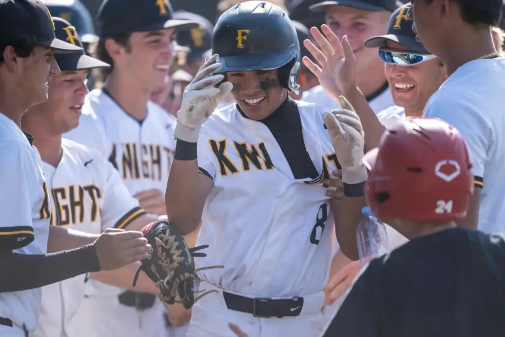 Foothill players congratulate infielder Jason Gugino as he returns to...