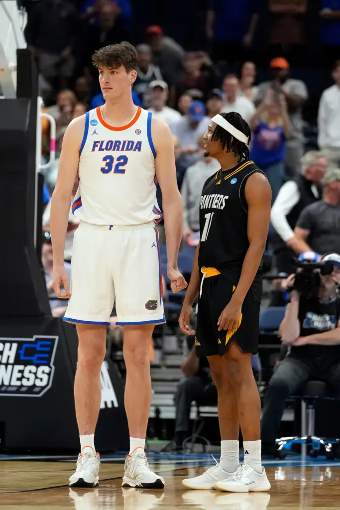 Seven-foot-9 Florida center Olivier Rioux, left, stands beside Prairie View...