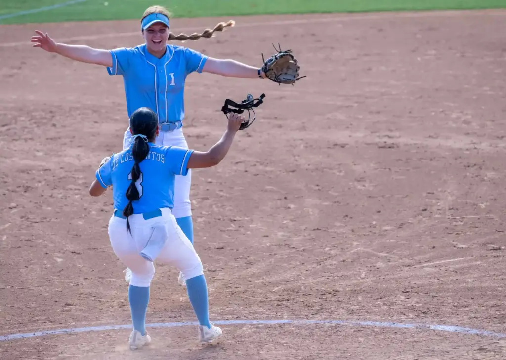 Irvine third baseman Harper Vandermolen, top, and pitcher Midori De...