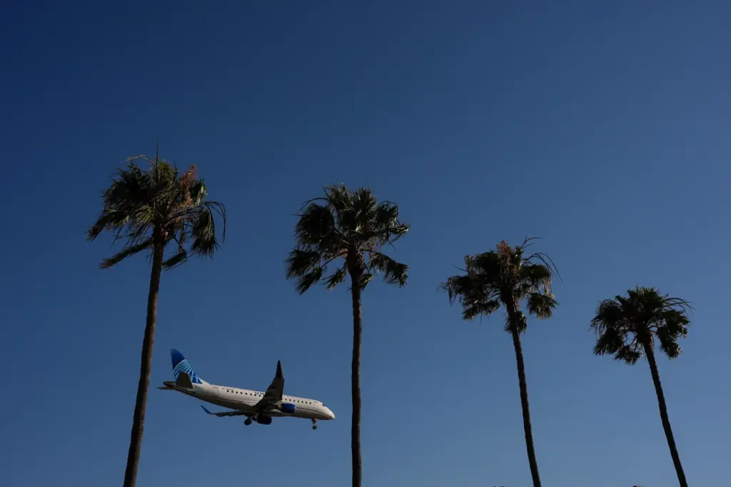 A United Airlines passenger jet approaches Los Angeles International Airport...