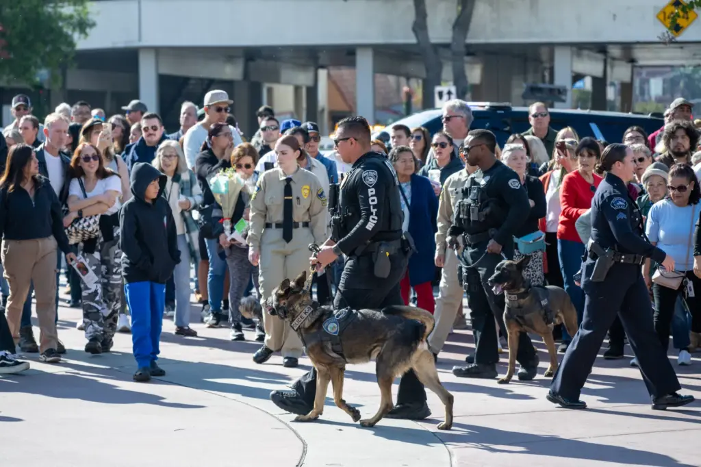 People line the street during a memorial ceremony for Burbank...