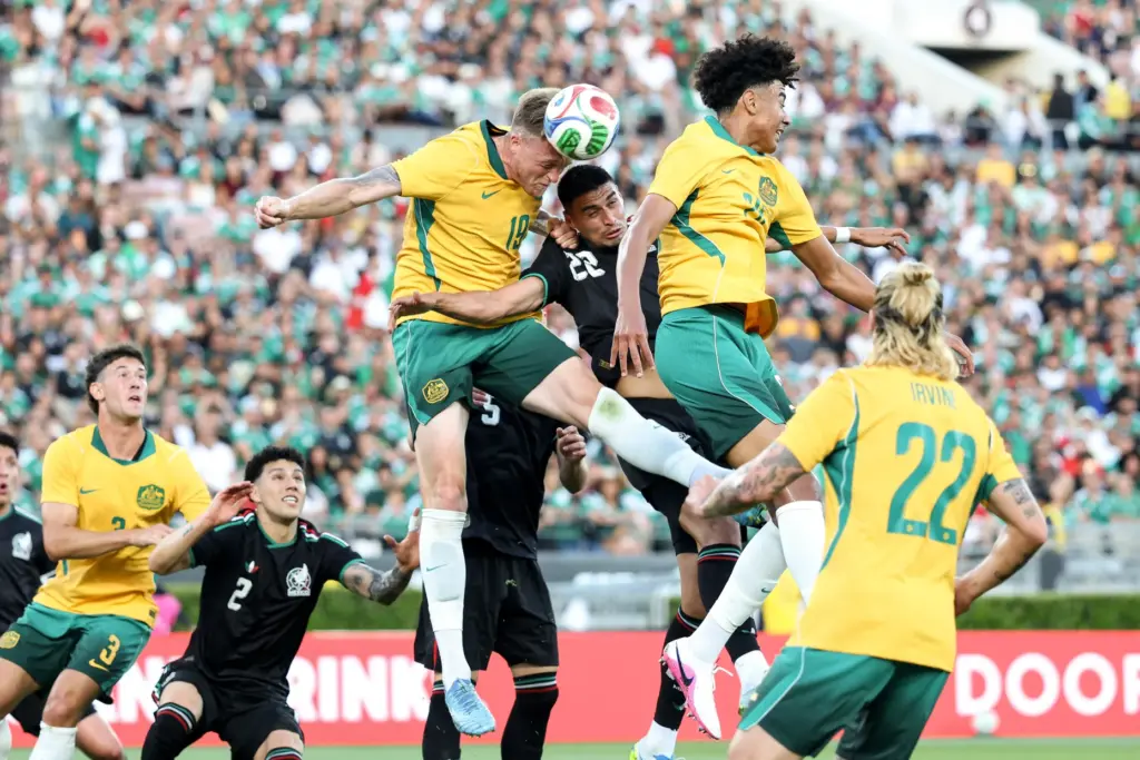 Australia defender Harry Souttar (19) heads the ball against Mexico...