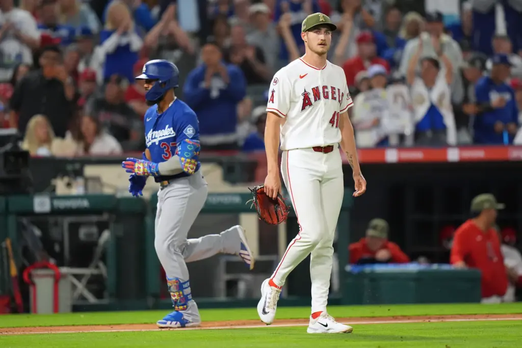 Angels starting pitcher Jack Kochanowicz, right, show his frustration after...
