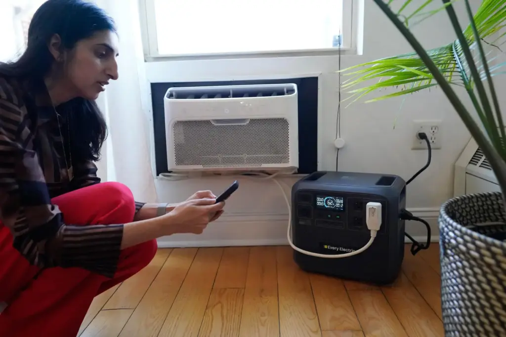 Sonam Velani hooks up a battery from Every Electric to power an air conditioner