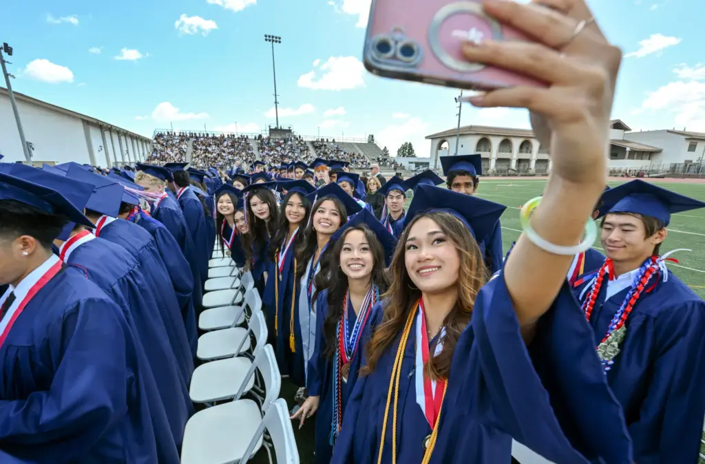 Olivia Tonnu takes a selfie with fellow graduates including Kiera...