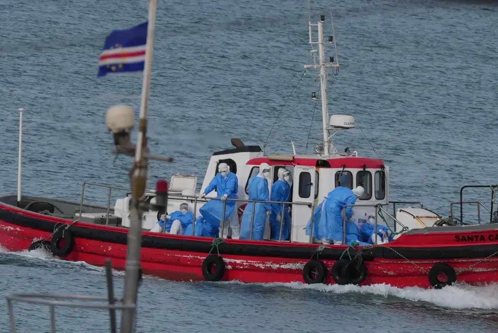 Health workers in protective gear arrive to evacuate patients from the MV Hondius cruise ship.