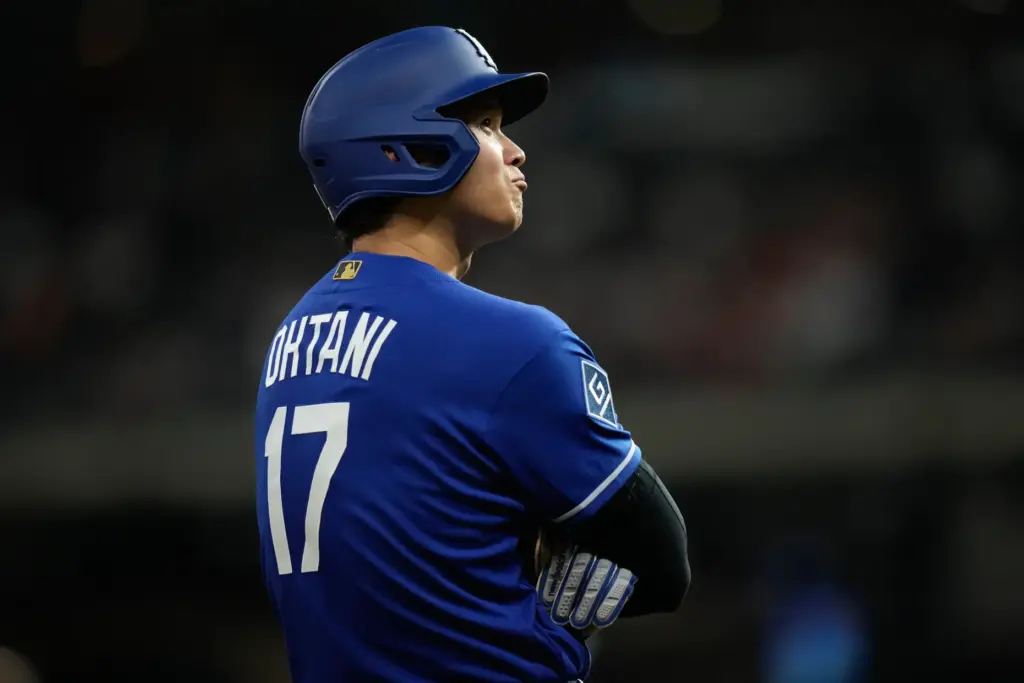 Dodgers designated hitter Shohei Ohtani stands on third base during...