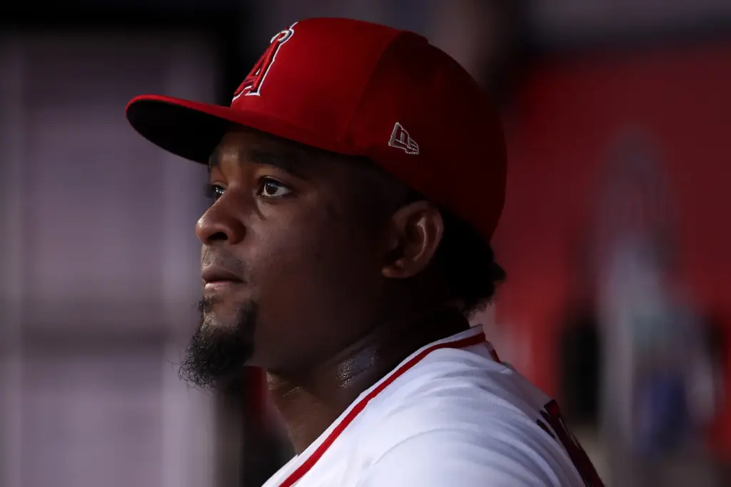 Angels starting pitcher JosÃ© Soriano looks on from the dugout...