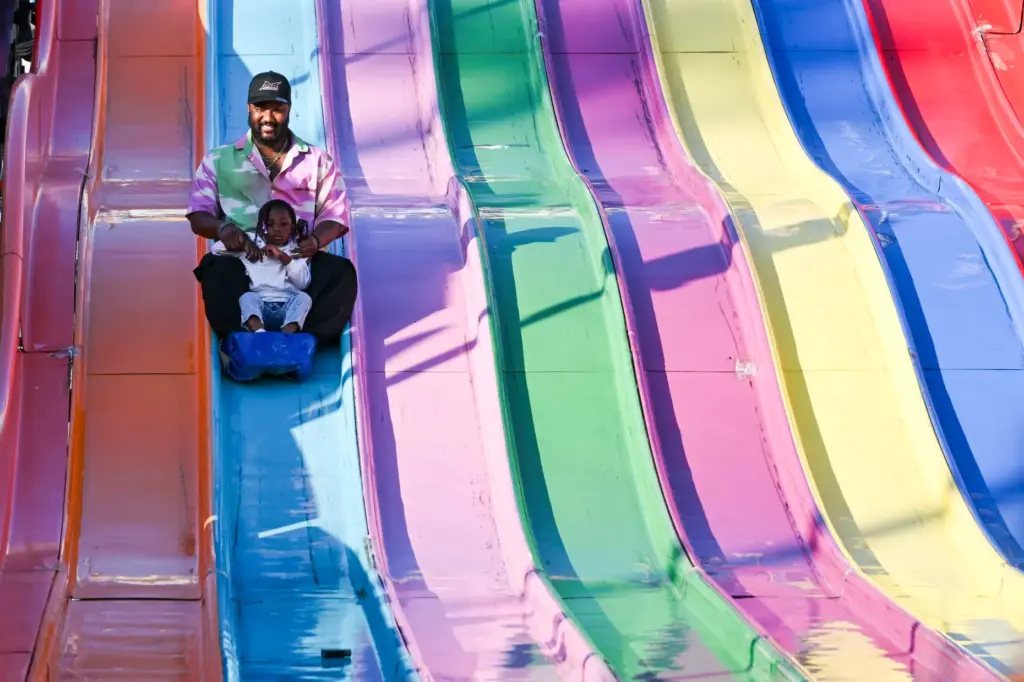 Micheal Lowe and daughter Eliza Lowe enjoy the slides during...