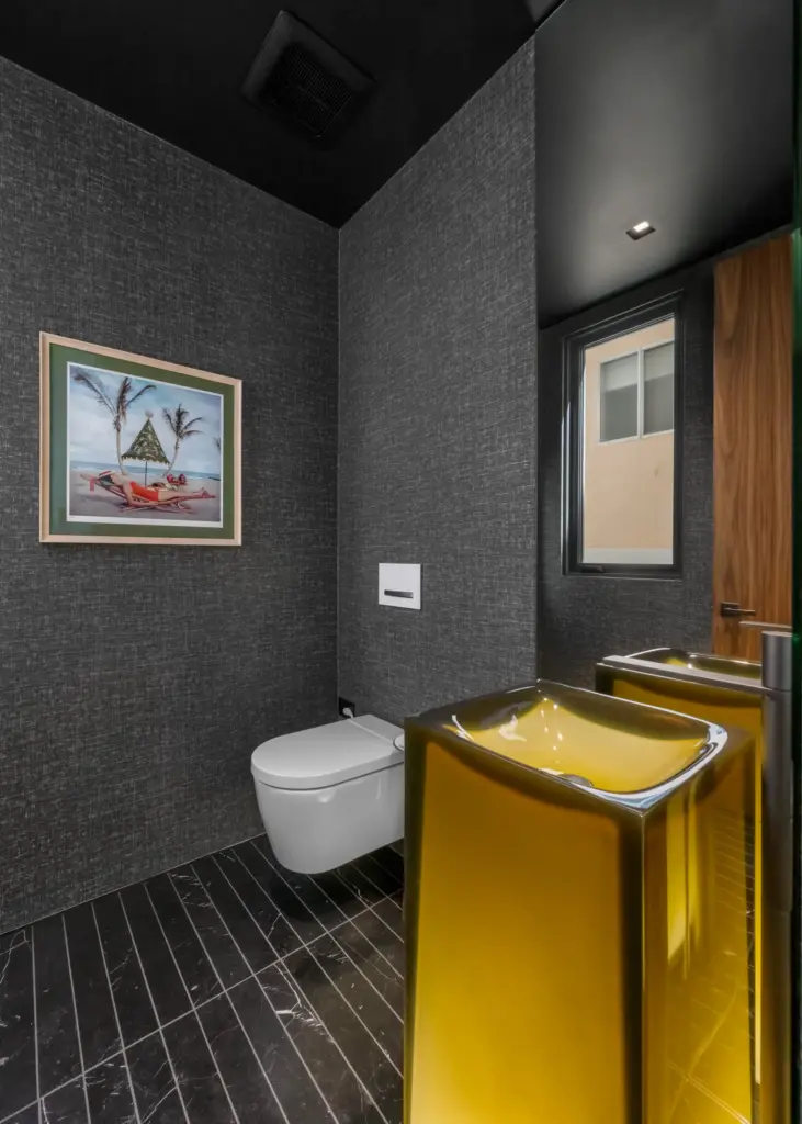 A freestanding Aura by Antoniolupi sink anchors one of two...