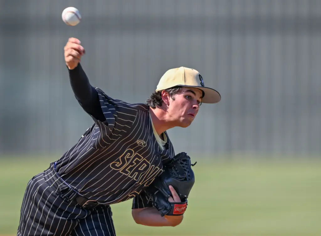 Servite starting pitcher Cole Grosthues throws to home plate during...