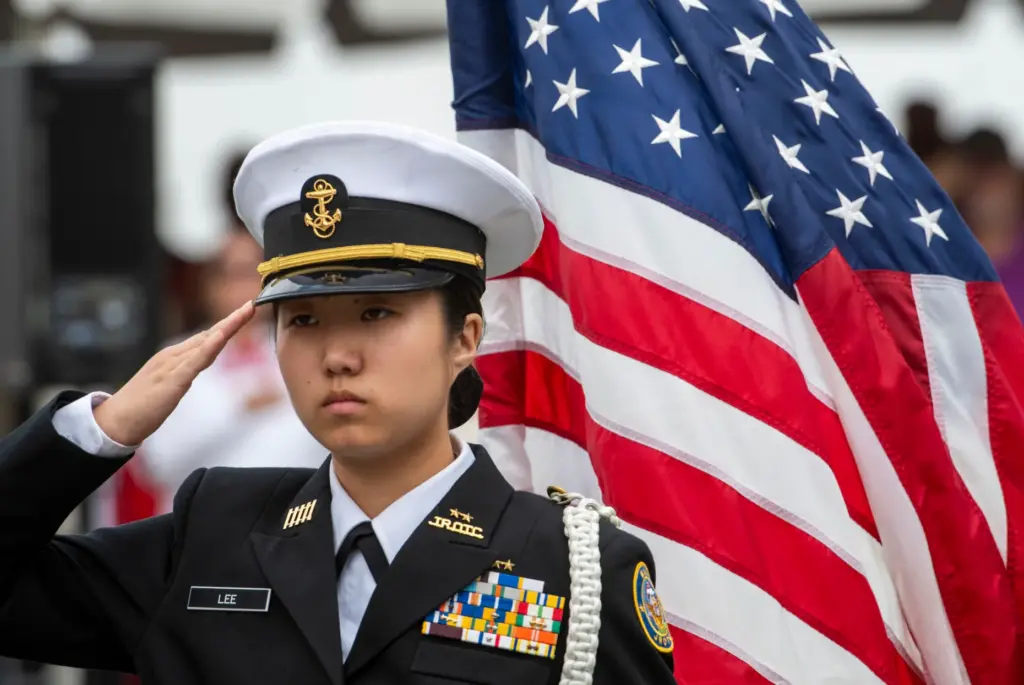 ROTC member Haying Lee of Troy High salutes during the...