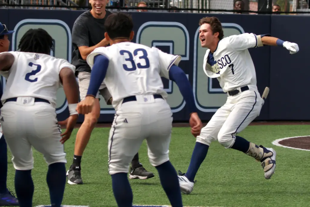 St. John Bosco senior Jack Champlin, right, is greeted by...