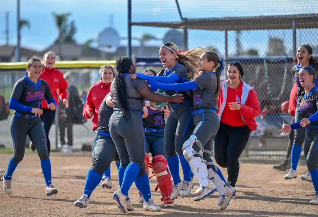 Los Alamitos players celebrate their 2-1 win over Marina following...