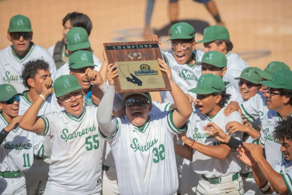 Schurrâs Joseph Tapia, (#32), holds up the championship plaque and...