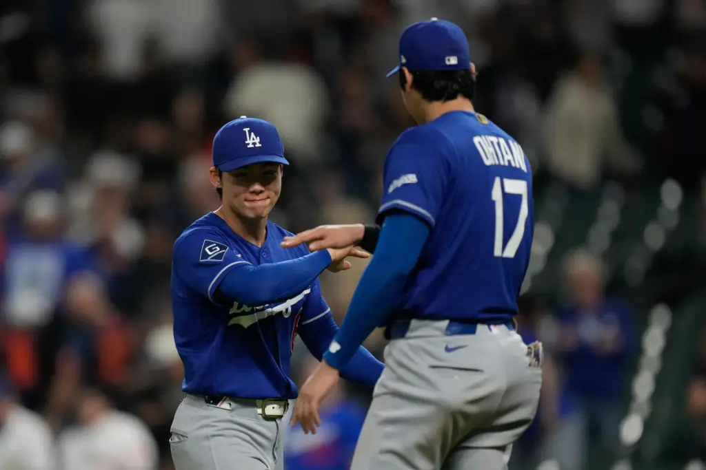 Dodgers shortstop Hyeseong Kim, left, celebrates with designated hitter Shohei...