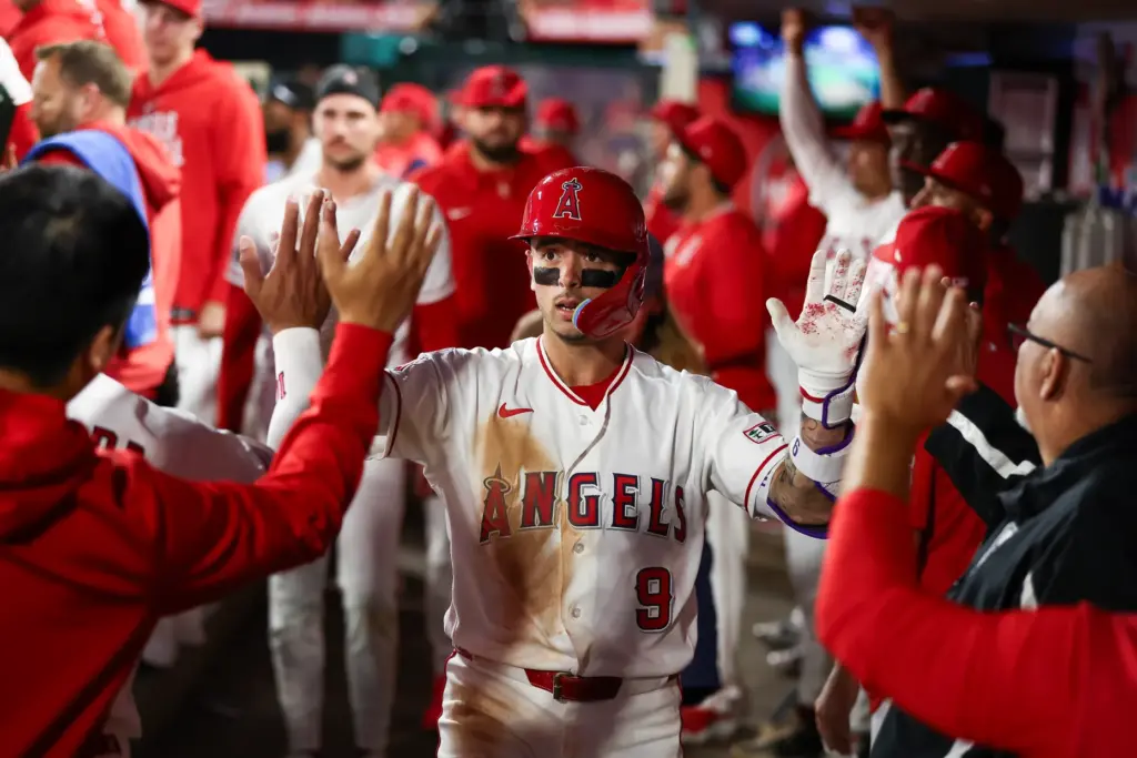 The Angels’ Zach Neto celebrates in the dugout after hitting...
