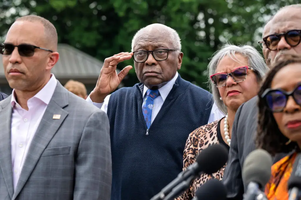 Rep. Jim Clyburn, D-S.C., center, stands with members of the Congressional Black Caucus