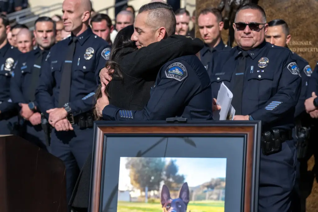 Burbank Police Chief Rafael Quintero hugs Burbank Mayor Nikki Perez...