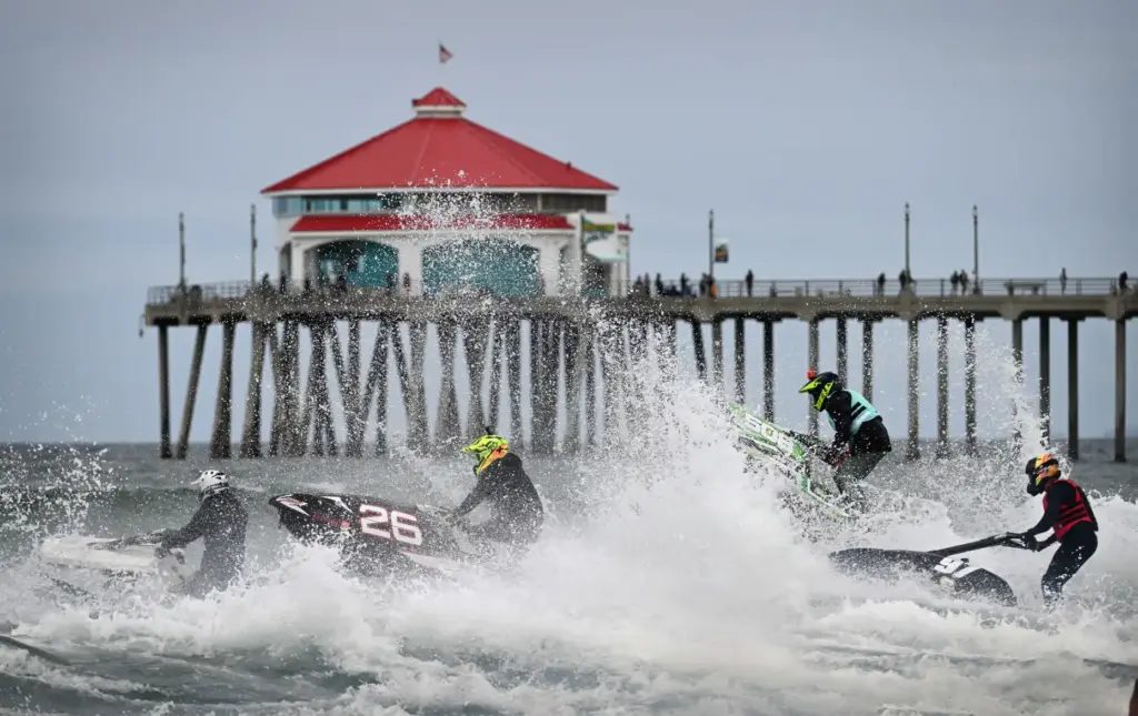 Moto-Surf racers take off at the start of their heat,...