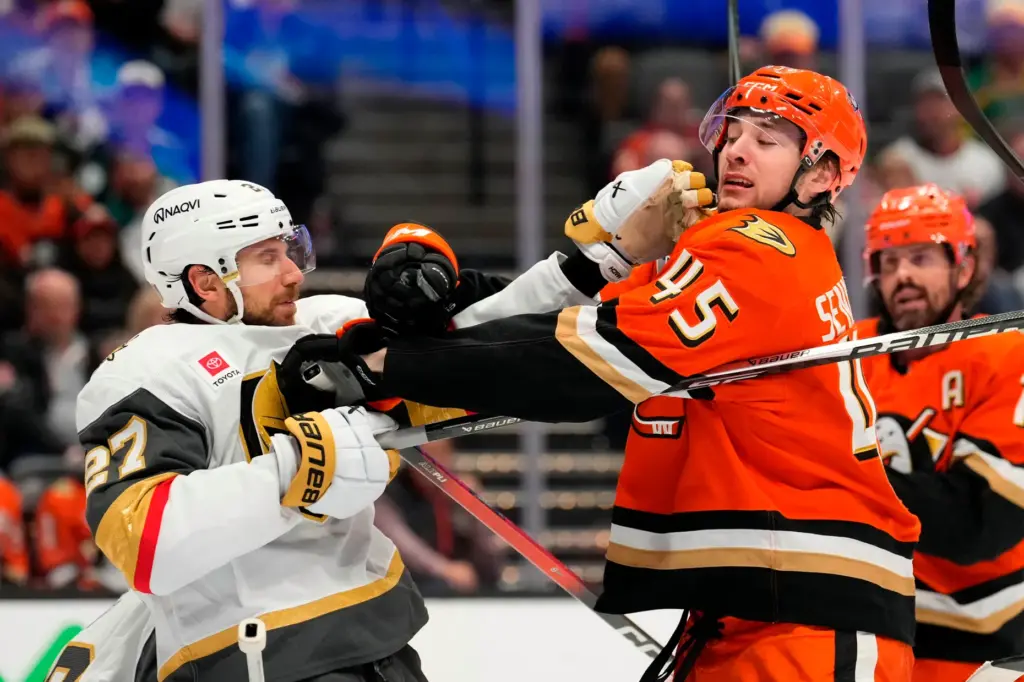 Vegas Golden Knights defenseman Shea Theodore, left, and Ducks right...