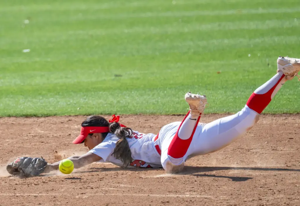 Mater Dei shortstop Alexandra Carrillo dives for the ball but...
