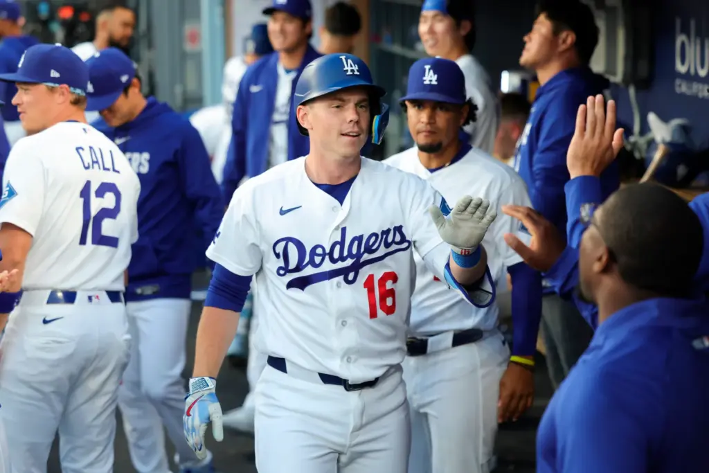 Dodgers designated hitter Will Smith celebrates in the dugout after...