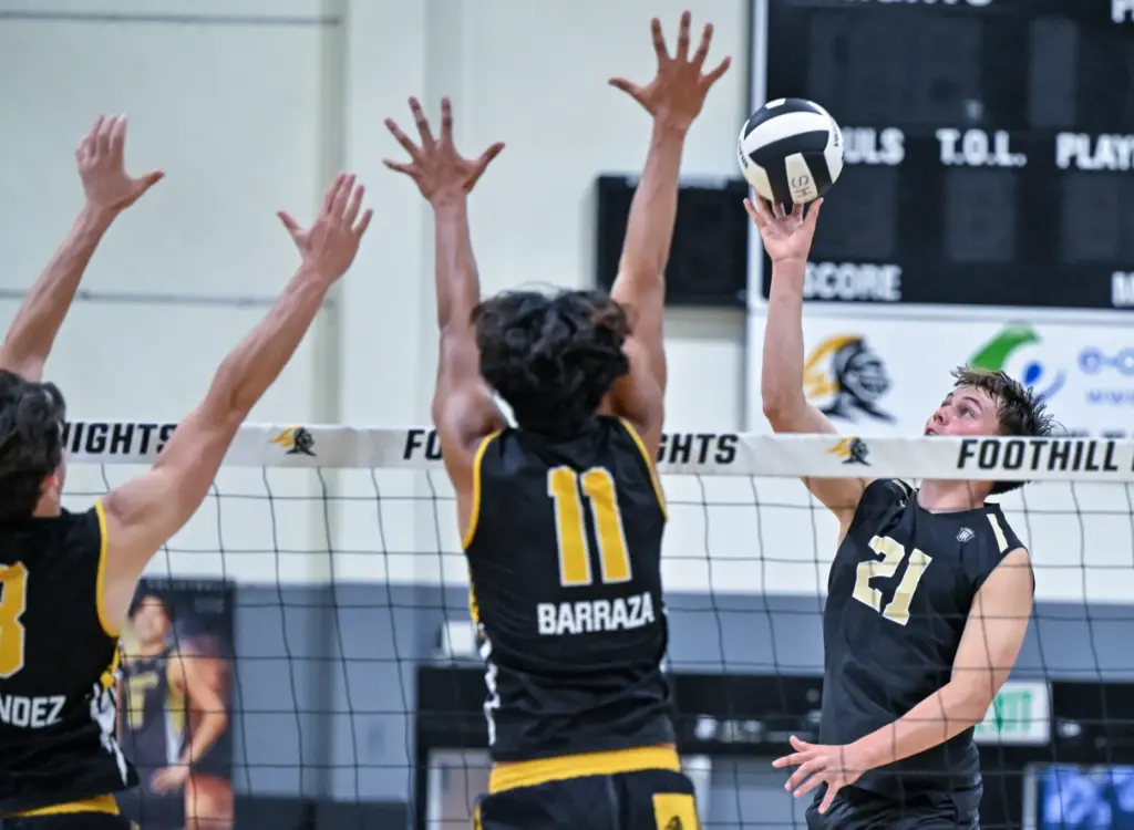 Servite outside hitter Jake Schutt tips the ball over Foothill...