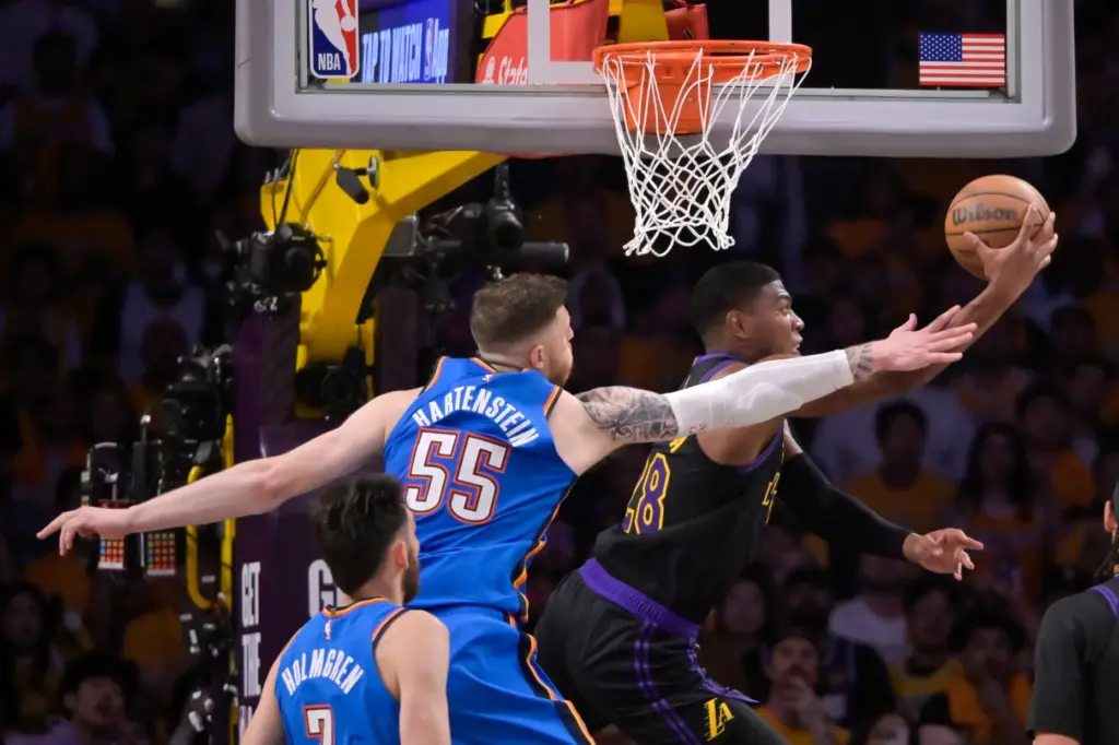 Lakers forward Rui Hachimura, right, makes a reverse layup as...