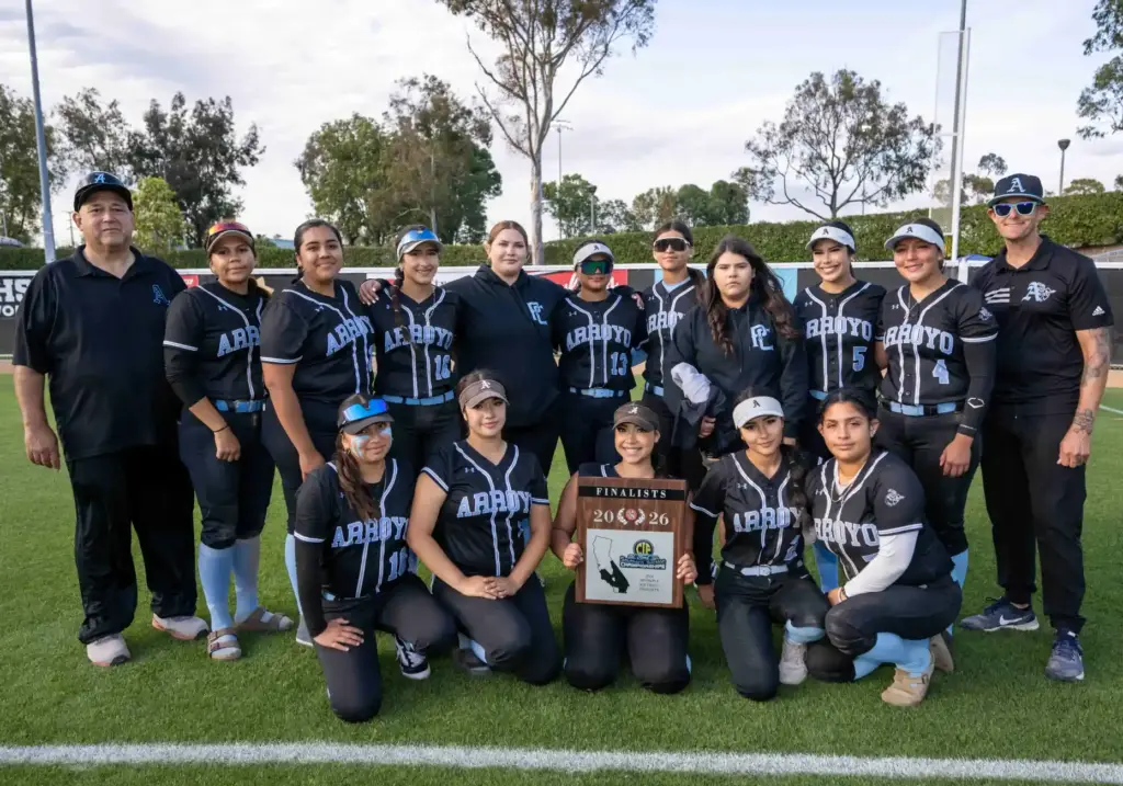 Arroyo players and coaches pose with their runner-up trophy following...