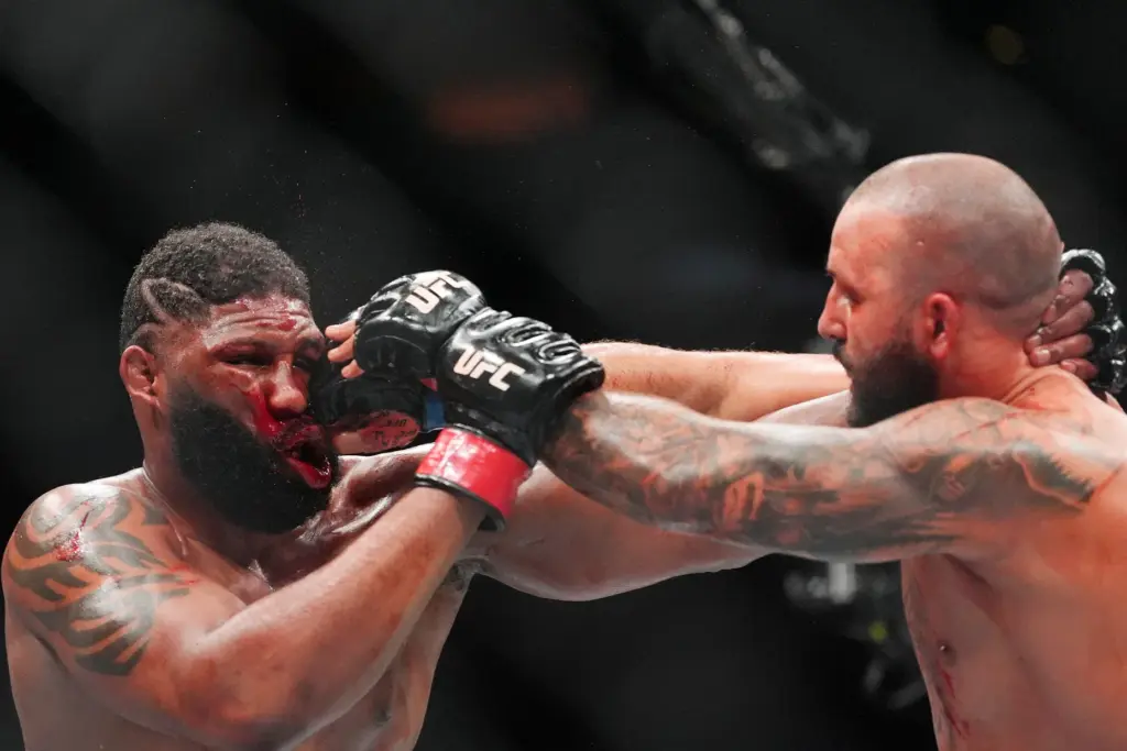 Curtis Blaydes, left, of the United States, absorbs a punch...