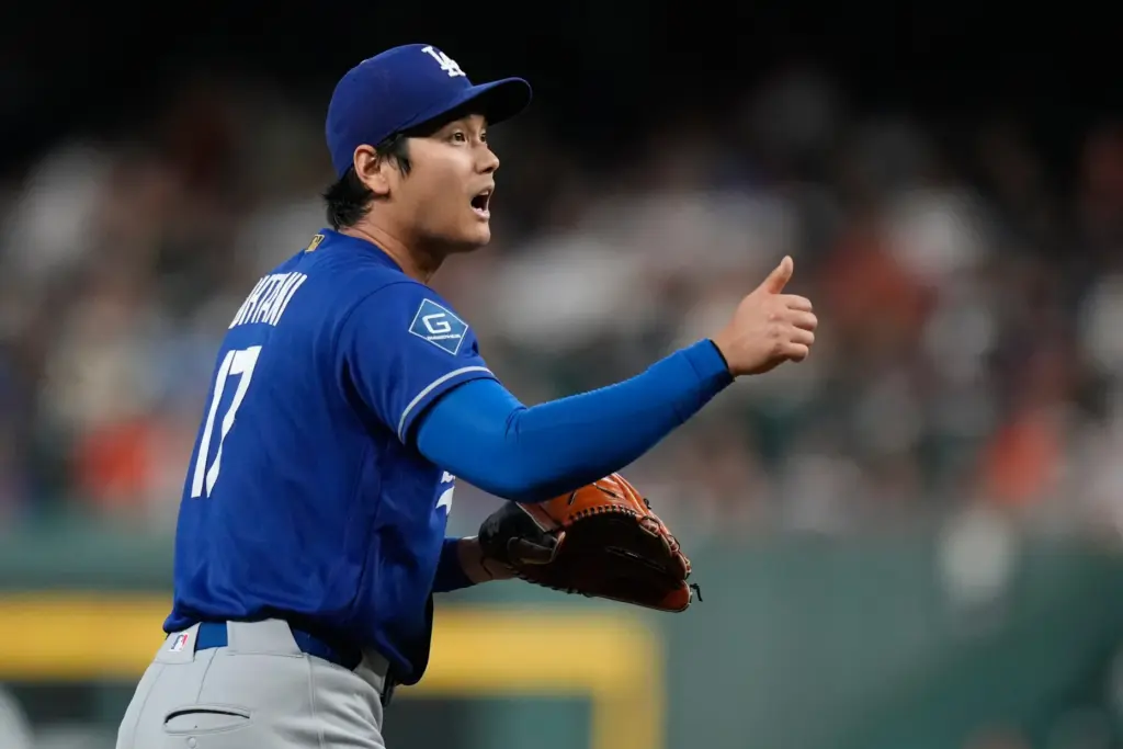 Dodgers starting pitcher Shohei Ohtani reacts to the umpire during...