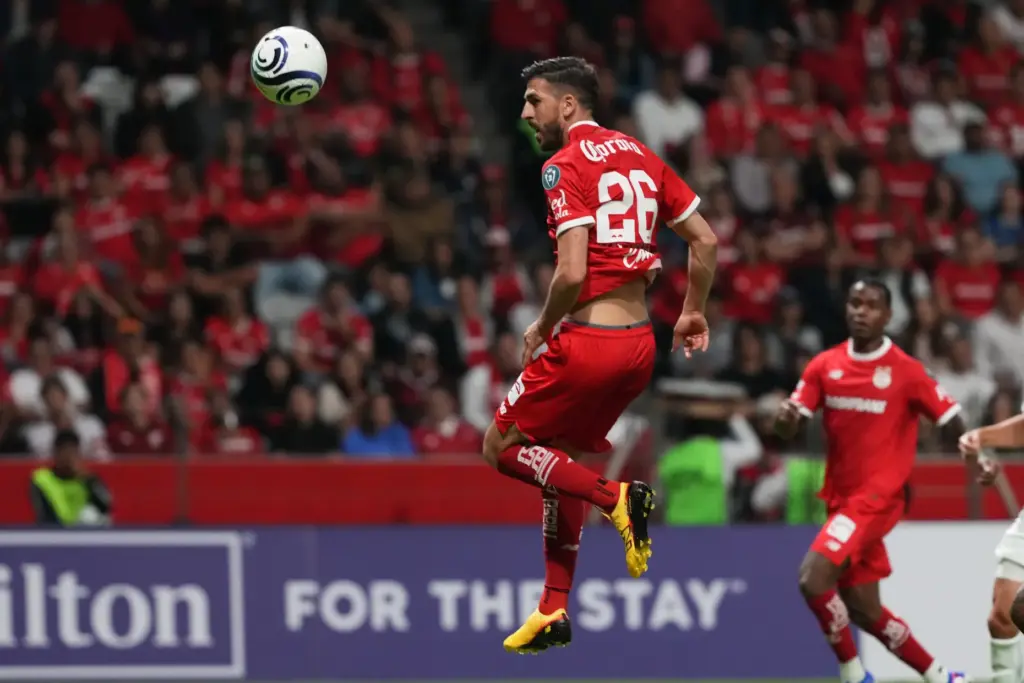 Toluca FC’s Paulinho jumps to make a play on the...