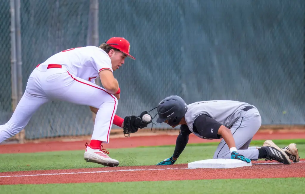 Santiago’s Ben Rausch, right, reaches third base safely on a...
