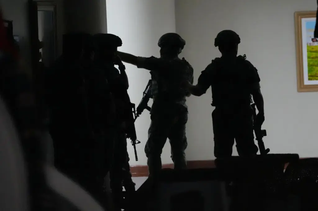 Philippine troopers exchange fire along a hallway at the Philippine...
