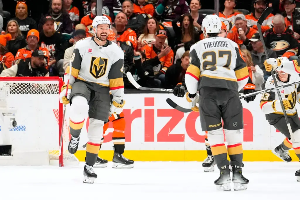 Vegas Golden Knights defenseman Shea Theodore, right, celebrates his goal...