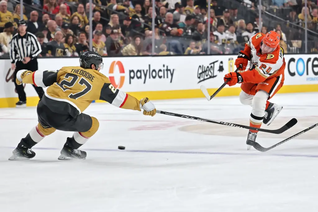 The Ducks’ Jansen Harkins, right, scores an empty-net goal past...