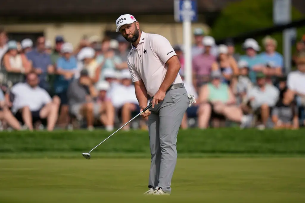 Jon Rahm, of Spain, putts on the 18th green during...