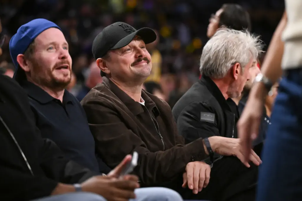 Actor Leonardo DiCaprio, center, watches Game 4 of the Lakers’...