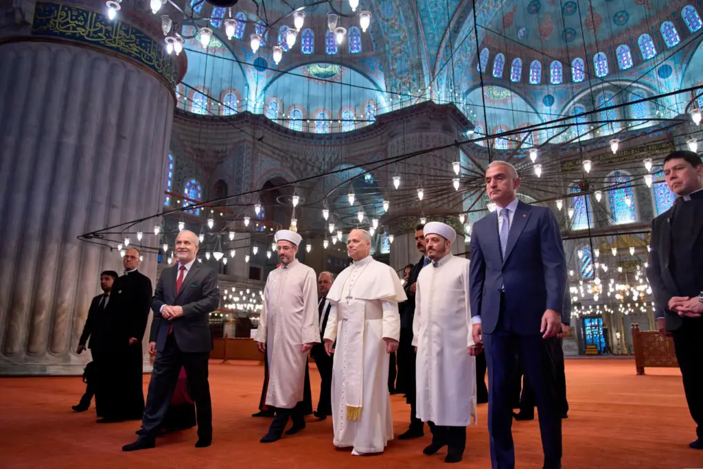 Pope Leo XIV walks with Muezzin Musa AsgÄ±n Tunca, Mufti Emrullah Tuncel, Fatih Kaya and Mehmet Nuri Ersoy.