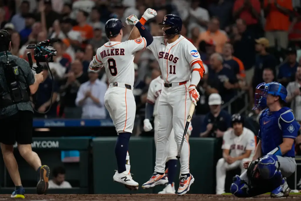 Houston Astros designated hitter Christian Walker, left, celebrates with teammate...