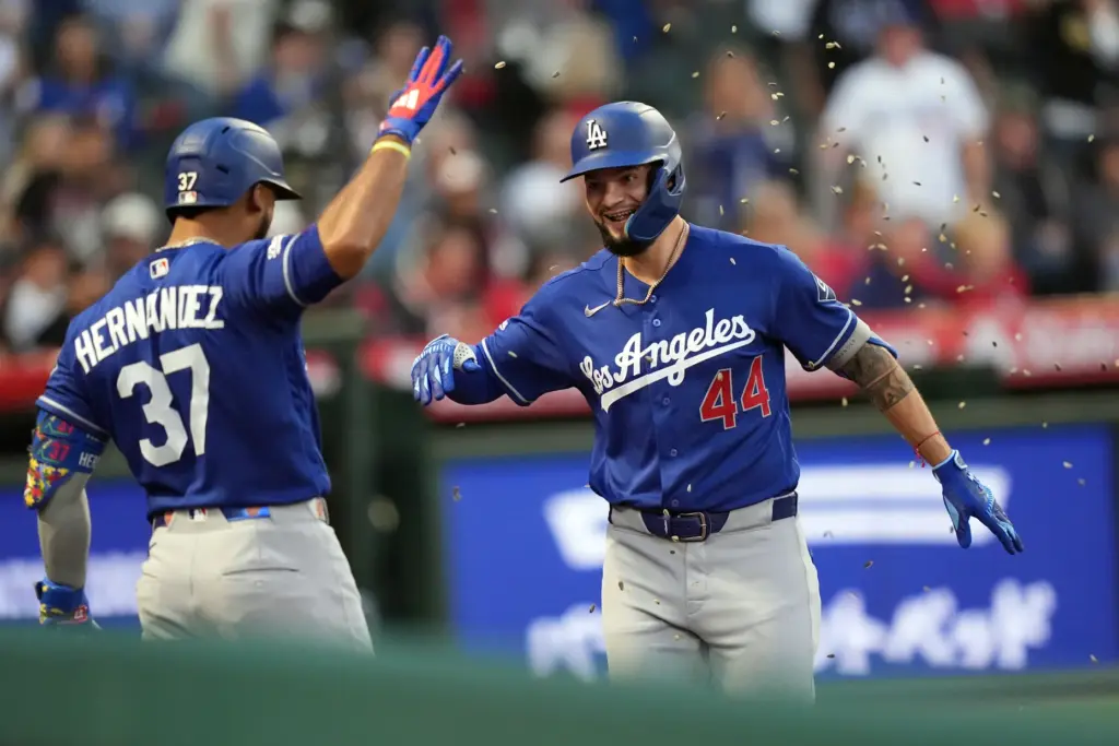 The Dodgers’ Andy Pages, right, is showered with sunflower seeds...